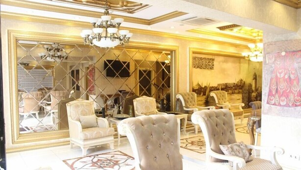 A luxurious interior with high-backed chairs, a chandelier, and ornate decor. - Marmara Deluxe Hotel (Istanbul)