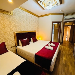 A hotel room with a large bed, two bedside tables, and a red throw blanket. - Marmara Deluxe Hotel (Istanbul)