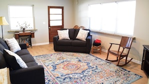 A living room with a sofa, a rocking chair, a coffee table, and a patterned rug. - 3bd, 1ba across from Pocosin Lakes Wildlife Refuge (Pantego)