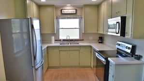 A kitchen with a stainless steel refrigerator, a sink, and a stove. - 3bd, 1ba across from Pocosin Lakes Wildlife Refuge (Pantego)