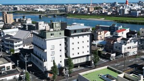 A cityscape with a river, buildings, and a prominent red and white tower. - Nobeoka Hotel (Nobeoka)