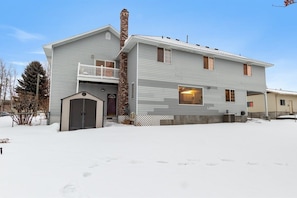 A two-story house with a covered front porch and a garage.