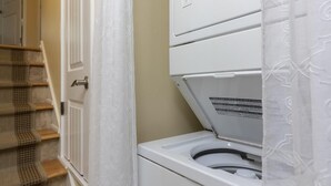 A laundry room with a front-loading washing machine and a dryer.