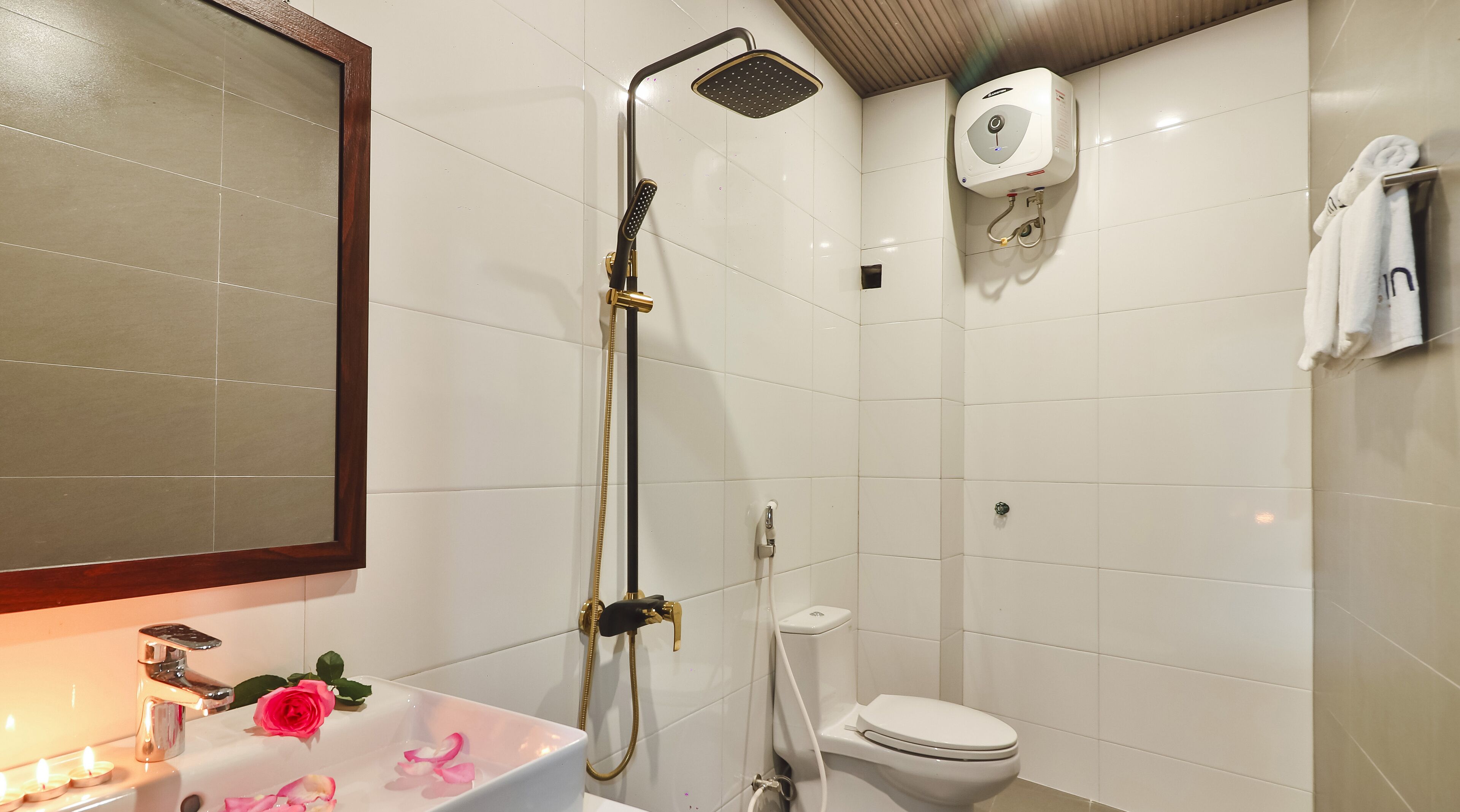 A bathroom with a shower, toilet, and sink.