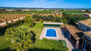 A pool area with a clear view of the surrounding landscape, including fields and distant buildings. - Beautiful Country Home “Son Vanrell” with Mountain View, Pool, Wi-Fi, A/C, Terrace & Garden; (Campos)