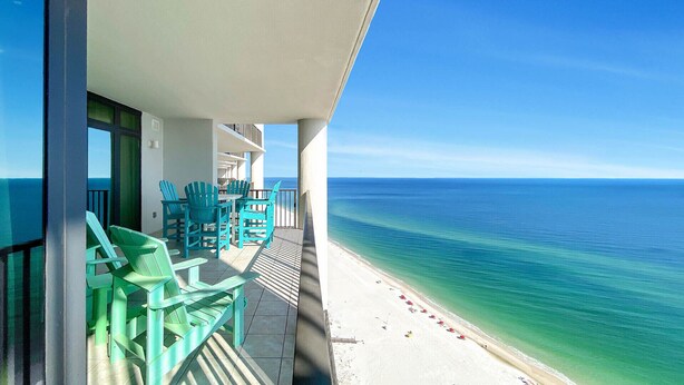 A balcony with turquoise chairs and a view of the ocean. - New Owner and New to the Rentals Market!  Lazy River/Slide! (Orange Beach)