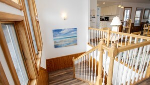 A wooden staircase with white balusters leading to a second floor. - Oceanside, Dogs Welcome, Private Pool, Hot Tub, Close to Beach Access, OL626, Celtic Dunes (Corolla)
