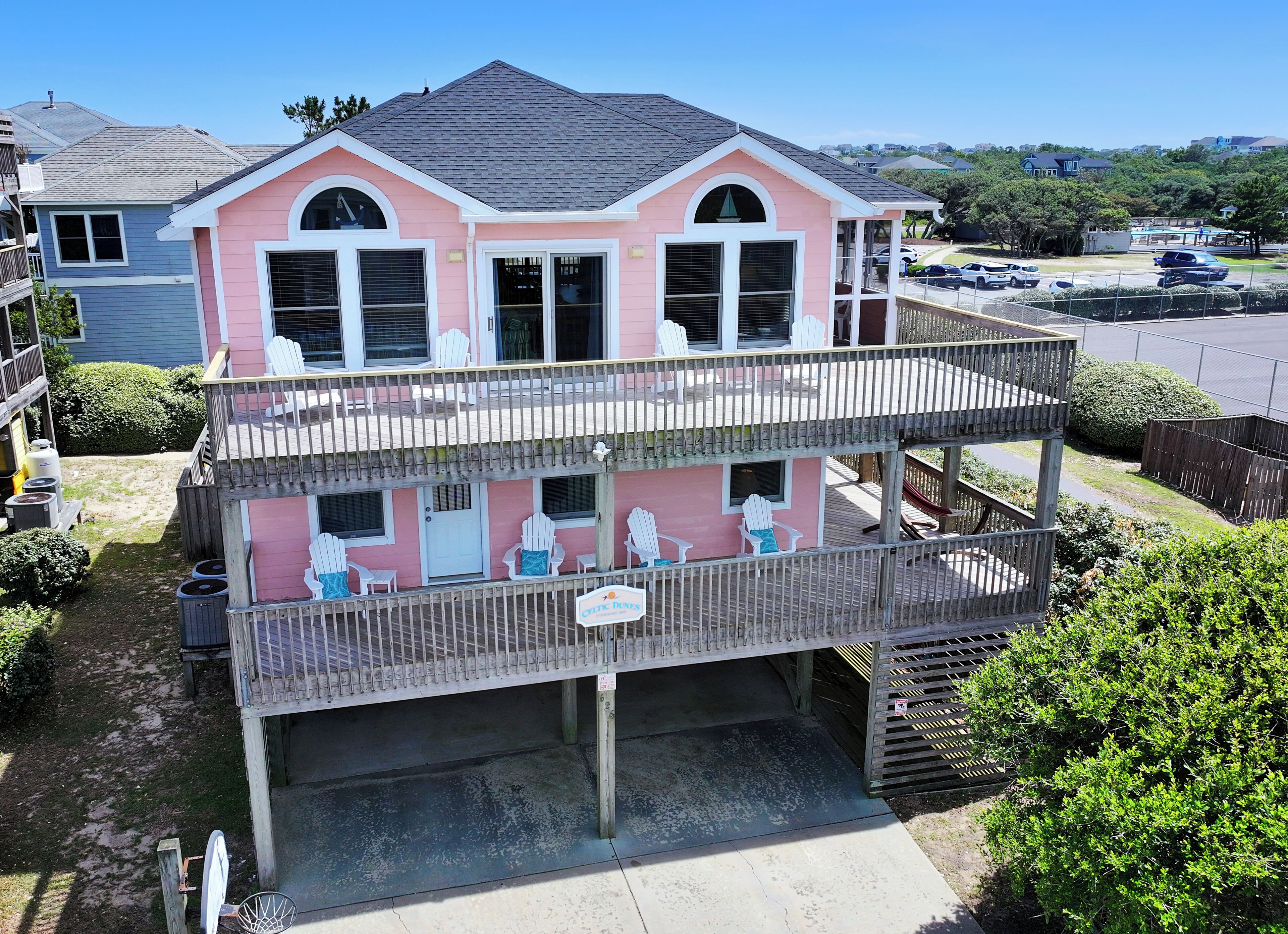 A two-story house with a balcony, a garage, and a visible driveway.