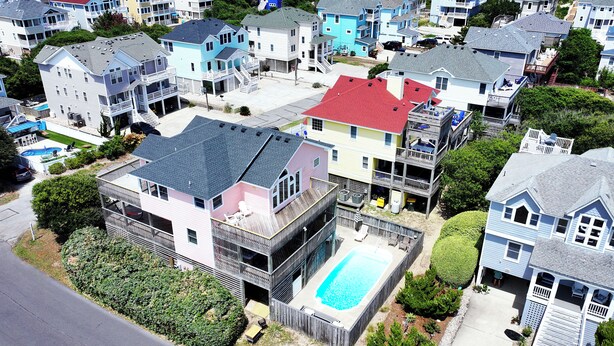 A residential area with houses, a swimming pool, and a beach in the background. - Oceanside, Dogs Welcome, Private Pool, Hot Tub, Close to Beach Access, OL626, Celtic Dunes (Corolla)