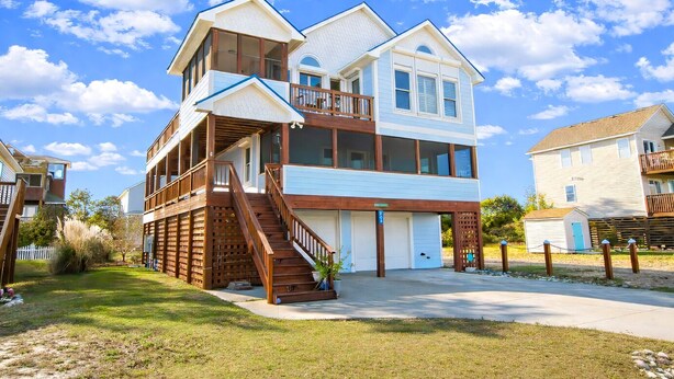 A two-story house with a balcony, a front porch, and a garage.