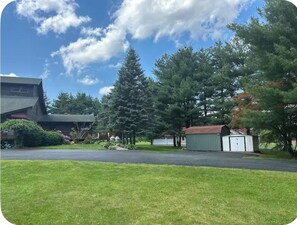 A residential area with a large building, a garage, and a small shed. - Spectacular Log Home Estate North Wing Unit (Marlboro)