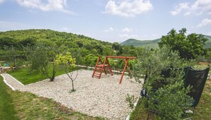 Relax in a serene natural setting surrounded by lush greenery and rolling hills.