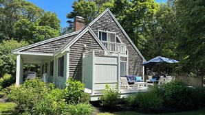 A house with a covered porch, a fenced backyard, and a car parked outside. - Osterville Gem with Central A/C and Walking Distance to Joshua’s Pond! (Osterville)
