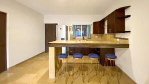 Enjoy cooking in this kitchen with a central island, sink, and bar stools.