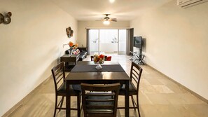 Dine in style with a table set for four in this beautifully designed dining area, offering a pleasant view of the outdoors.