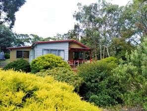 Set amidst lush greenery, this charming single-story building offers a serene retreat.