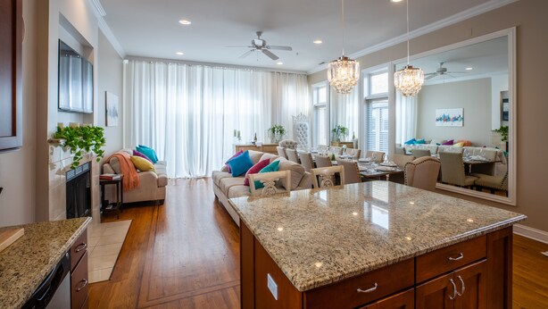 A modern kitchen with granite countertops, wooden cabinets, and a central island. - NEW LUXURY PENTHOUSE CONDO (Chicago)