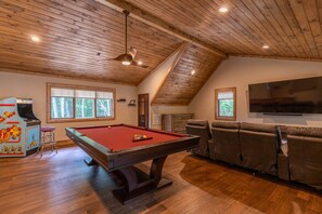A pool table in a room with wooden ceilings and large windows. - Bear Creek Cabin at Eagles Nest - Hot tub, pool table, fire pit! (Banner Elk)