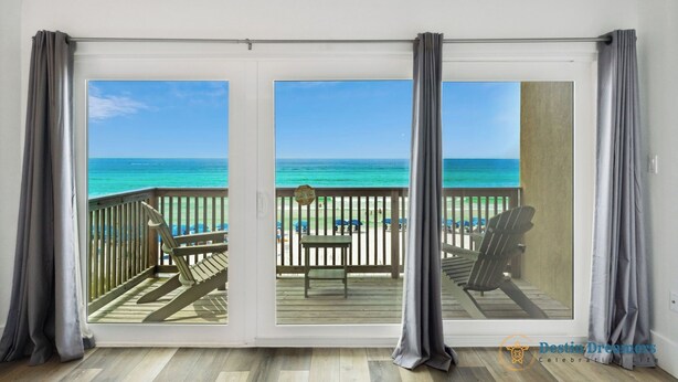A balcony with a view of the ocean, a wooden deck, and a table and chairs. - 🐚 Silver Beach Retreat | Beachfront | FREE VIP Package | Beach Chair Service (Destin)