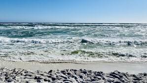 A beach with waves crashing onto the shore under a clear sky. - 30A Home in Seacrest - PRIVATE POOL - Peak-A-Boo Ocean View 2 min Walk to Beach (Seacrest)
