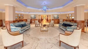 A spacious lobby with a central chandelier, multiple seating areas, and a marble floor. - Elegant Oceanfront 2 Bedroom 2 Bath Ocean View Condo at Maisons-Sur-Mer in Myrtle Beach (Myrtle Beach)