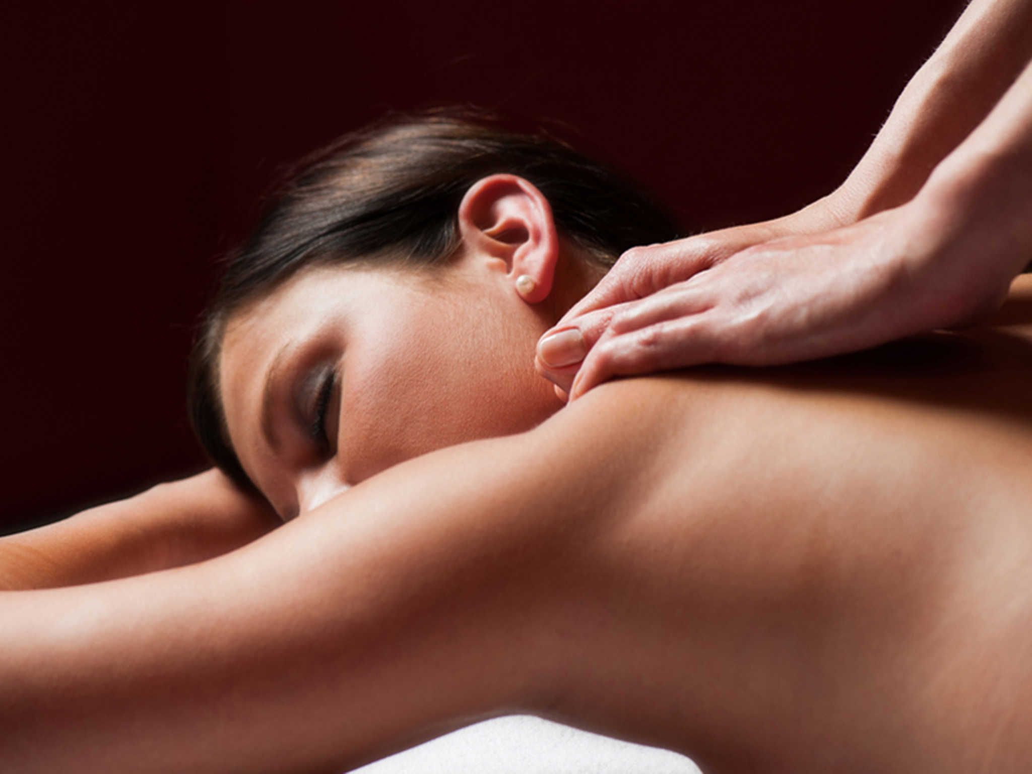 A person receiving a back massage.