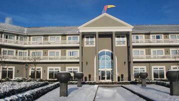 A multi-story hotel with a symmetrical facade, large windows, and a central entrance.