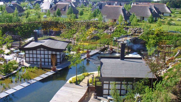 A riverside property with traditional architecture, a dock, and a small garden. - Hotel room (a) - Van der Valk Resort Linstow Hotel (Dobbin-Linstow)
