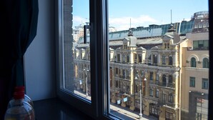 A view from a window overlooking historic buildings with classical architecture, including a building labeled "BROCA." - Arena and Kreshatik, best location, VIP Studio  (Київ)