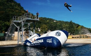 A water-based activity with a large inflatable structure and a platform with stairs. - Snowdonia Holiday Lodge, North Wales (Caernarfon)