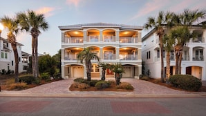 A multi-story hotel with balconies, palm trees, and a paved entrance area. - Destiny West, Huge Pool/Spa, Game Room, Gulf Views, Theater, Golf Cart Rental (Destin)