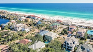 An aerial view of a coastal resort with beachfront properties, a swimming pool, and a clear view of the ocean. - Destiny West, Huge Pool/Spa, Game Room, Gulf Views, Theater, Golf Cart Rental (Destin)