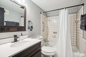 Combined shower/bathtub, hair dryer, towels, toilet paper