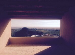 Enjoy a panoramic view of the surrounding landscape from the large window in this room.