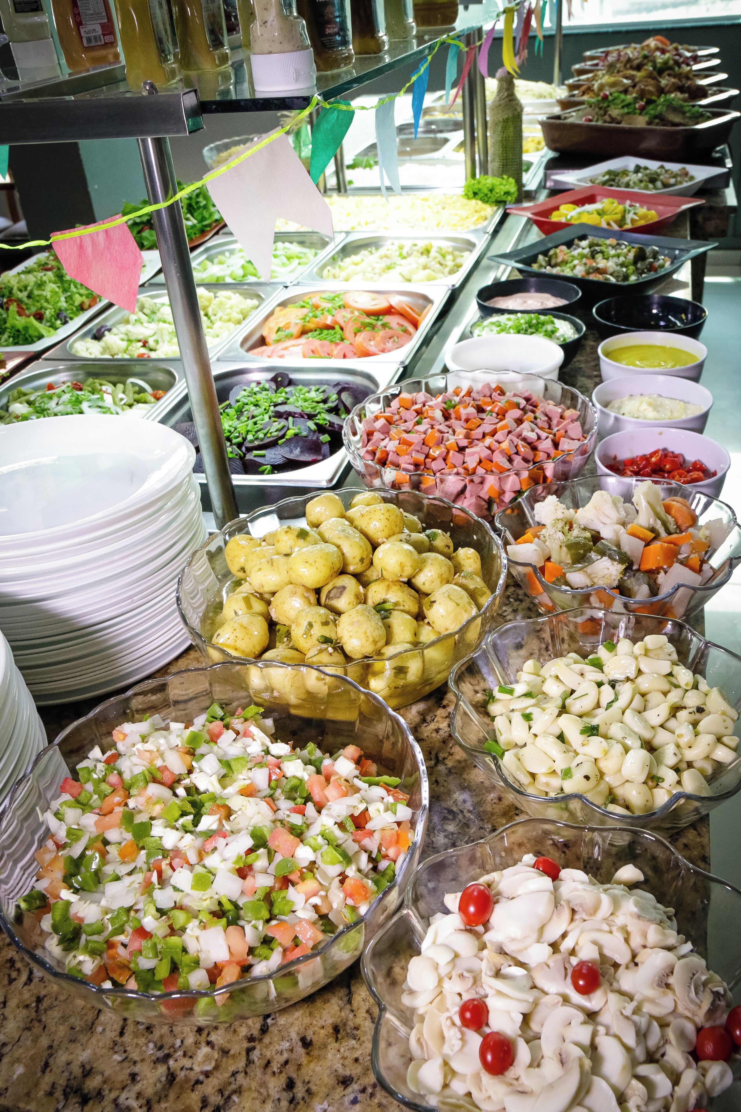 A buffet with various food items including salads, meats, and vegetables.