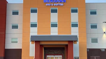 A multi-story hotel with the name "Meridian Inn & Suites" prominently displayed.
