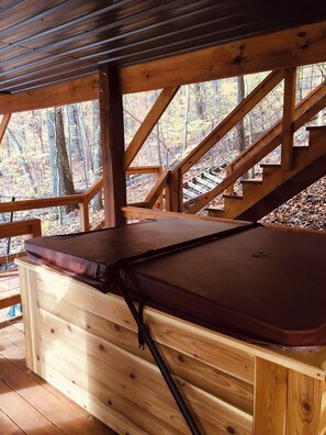 A wooden deck with a bench and a staircase leading to an upper level. - Barn Owl Inn Treehouse - Private Hot Tub (Guild)