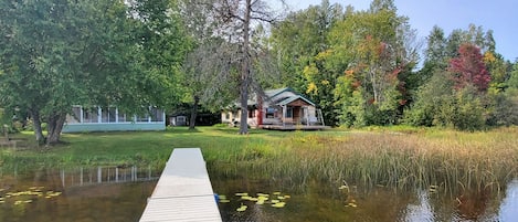 Escape to a serene lakeside retreat surrounded by lush greenery and tranquil water.