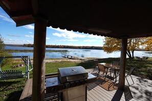 Outdoor dining - AuTrain Lake Sunrise Cabin w/Dock, private lakeside firepit. Near Pictured Rocks (Au Train)