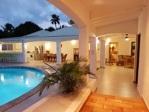 A pool area with a covered seating area, a kitchen, and a dining space. - Veronica Villa 3 bedrooms with pool in Orient Bay   (Saint Martin)