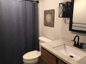Combined shower/bathtub, hair dryer, towels, toilet paper