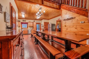 A spacious kitchen with wooden countertops, a central island, and built-in benches. - Ultimate Group Escape • Sleeps 28 • Pool • Dogs (Cosby)
