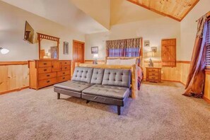 A room with a large bed, wooden furniture, and a high ceiling. - Poolin Around (Cosby)