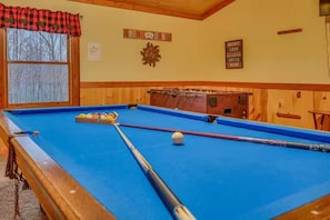 A pool table with balls and cues, a window with a view, and a sign that says 'WOBBY LESS SMILE MORE'. - Ultimate Group Escape • Sleeps 28 • Pool • Dogs (Cosby)
