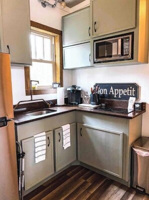Enjoy cooking in this well-equipped kitchen with a microwave, coffee maker, and ample counter space.