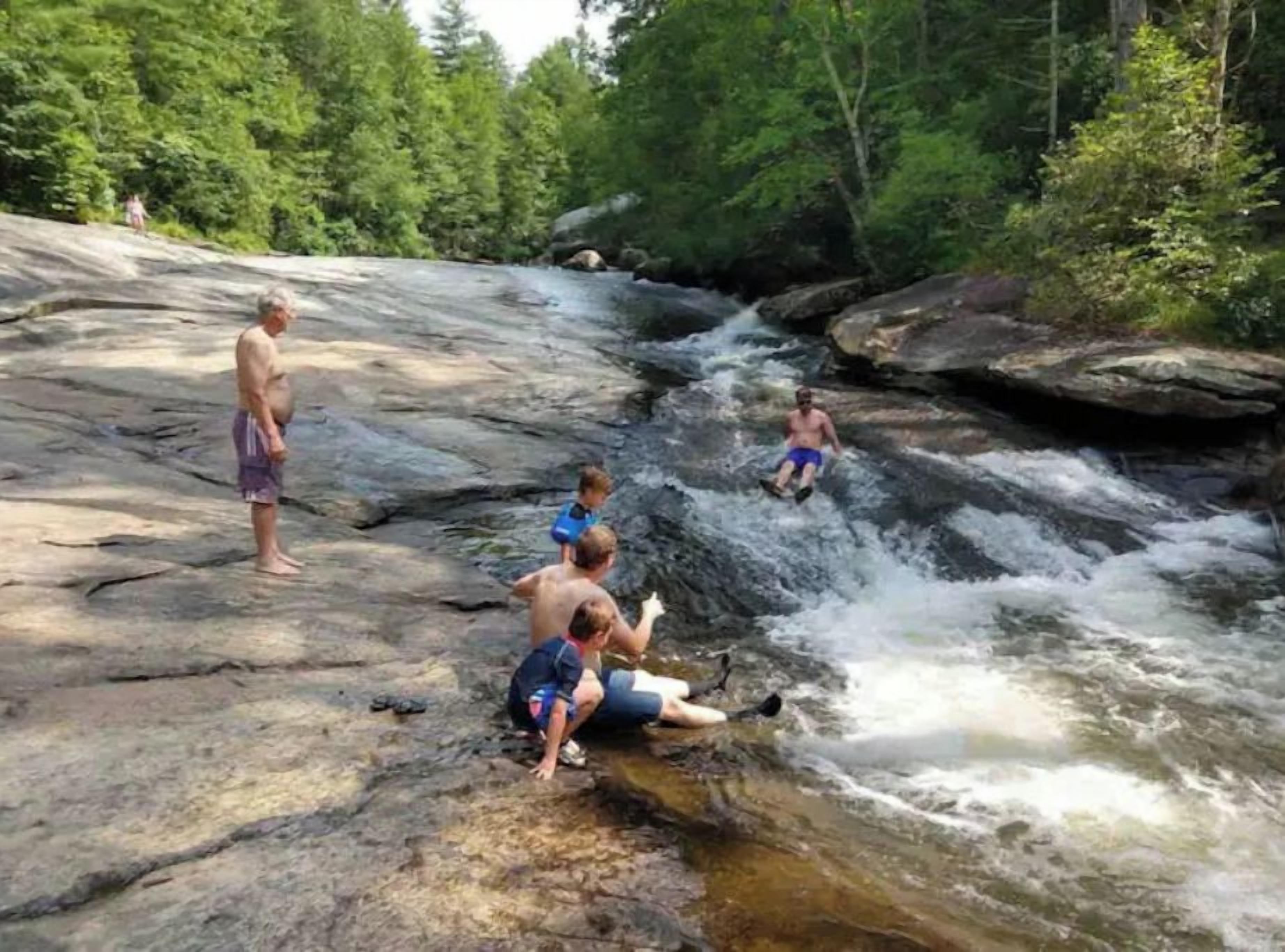A natural rocky landscape with a flowing stream.