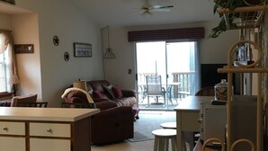 A spacious living area with a sofa, dining table, and a kitchen area.