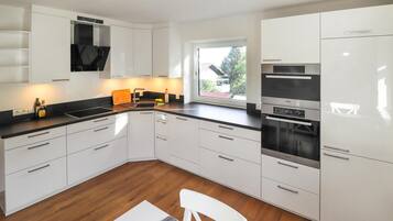 Fridge, stovetop, dishwasher, coffee/tea maker