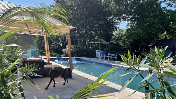 A pool area with lounge chairs, a covered seating area, and surrounding greenery. - Lg Victorian, New Resort-likePrivate Pool, Beds for 17, 10min to SH beach (Cape May Court House)