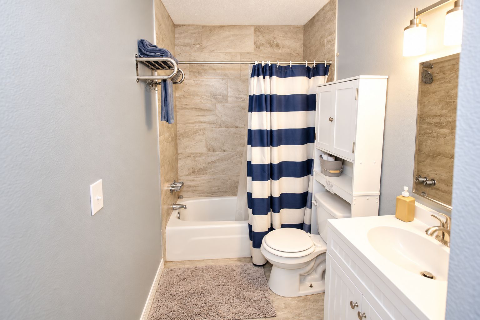 A bathroom with a bathtub, toilet, and sink.
